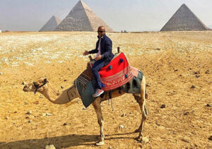 Dr. Hazie Simon riding a camel